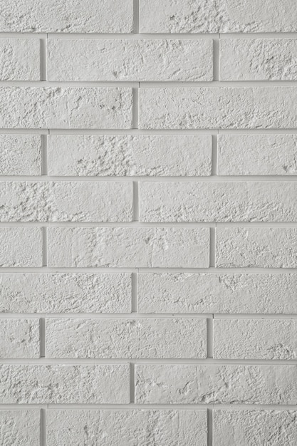 White wall of decorative gypsum bricks vertical background