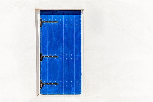 White wall with blue door