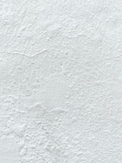 A white wall with a textured surface and a black arrow.