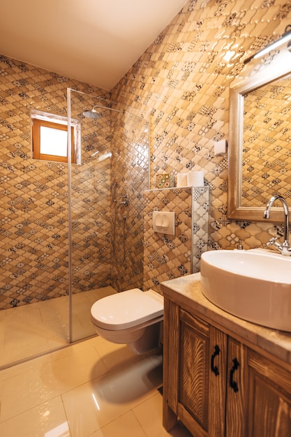 A white washbasin with a large mirror