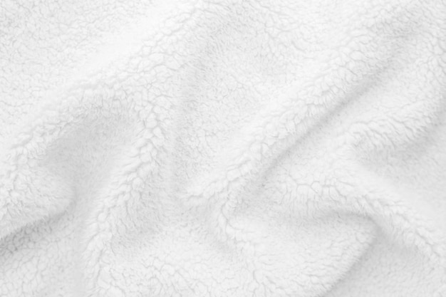 White wavy lambswool texture close up Warm sheep's wool fabric for blankets Lining for winter knitted plaid