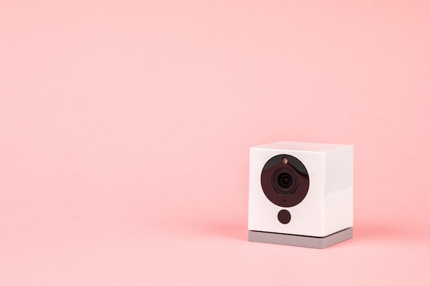 White webcam on pink background object Internet technology concept