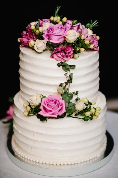 White wedding cake with pink flowers for wedding banquet Delicious wedding reception Copy space Celebration party concept Trendy Cake