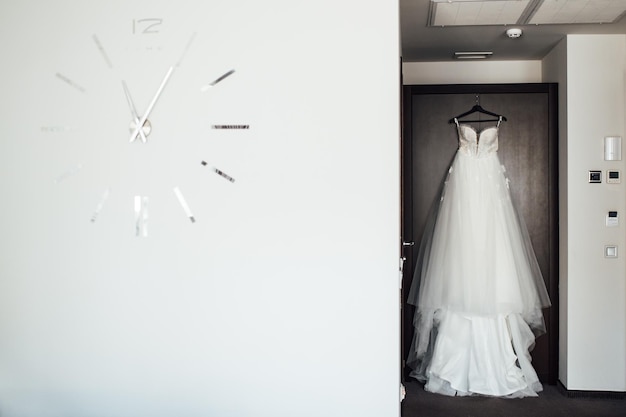 White Wedding dress on a shoulders before ceremony