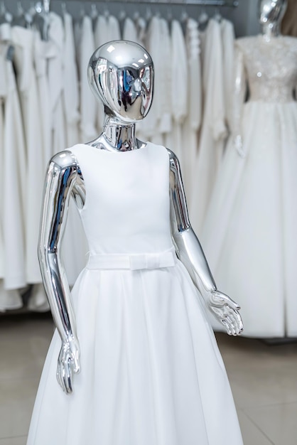 White wedding gowns on display at modern bridal shop showroom