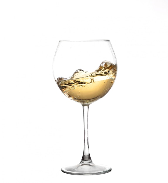 White wine swirling in a goblet wine glass isolated on a white background