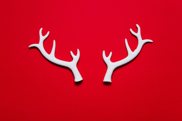 White winter festive christmas reindeer antlers on a red background