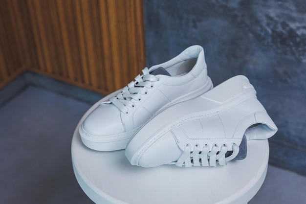 White women's leather sneakers closeup New collection of women's summer leather shoes