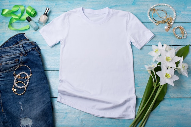 White womens cotton Tshirt mockup with white lilies bijouterie and nail polish