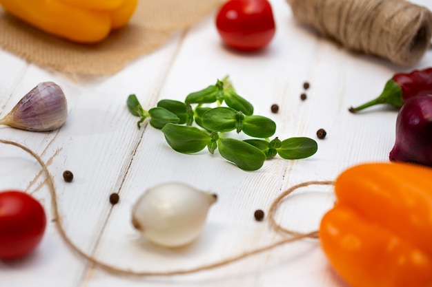 White wooden background of cooking. Spices, vegetables and seedlings of sunflower, microgreen.