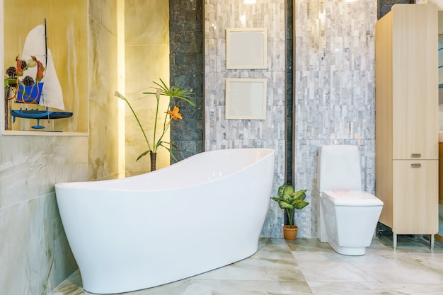 White and wooden bathroom with a white bathtub, a toilet and a built in shelf for self car