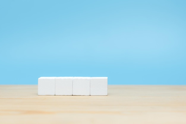 White wooden cube on table with copy space for text or icon