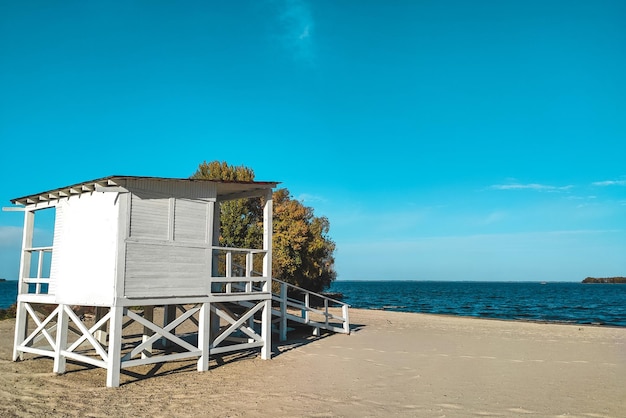 White wooden house for lifeguards on the water at the beach