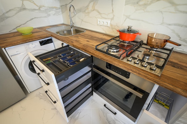 White and wooden modern kitchen furniture some drawers open