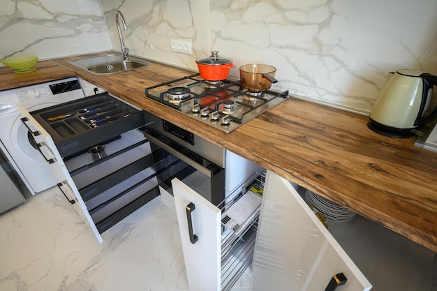 White and wooden modern kitchen furniture some drawers open