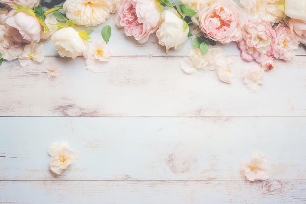 A white wooden table with pink and white flowers on it.