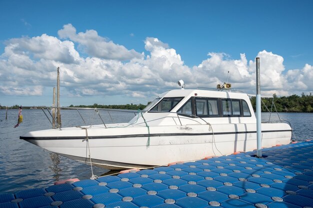 White yacht anchored in river at pier