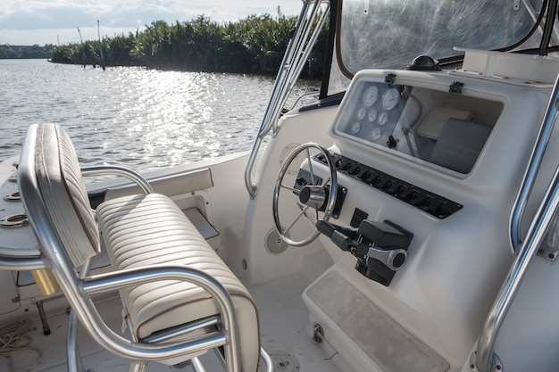 White yacht speed control panel with steering wheel