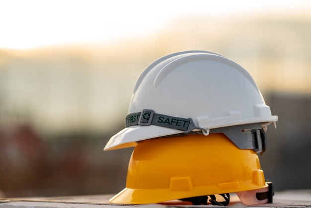 White and Yellow helmet hard hat safety in site construction,concept safety first.