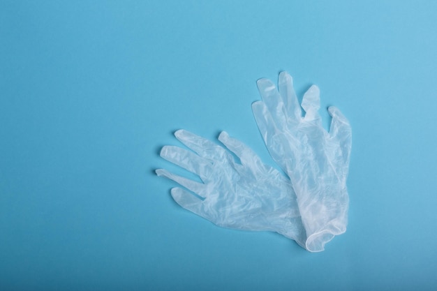 Whitte surgical gloves isolated on the blue background Concept protect against infection or contamination