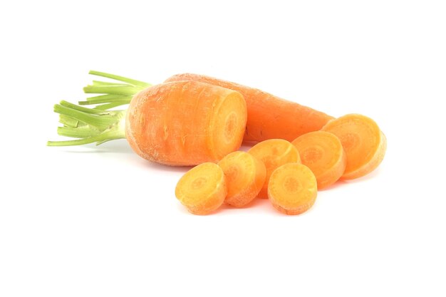 Whole carrot and sliced pieces all with a bright orange color isolated on a white background