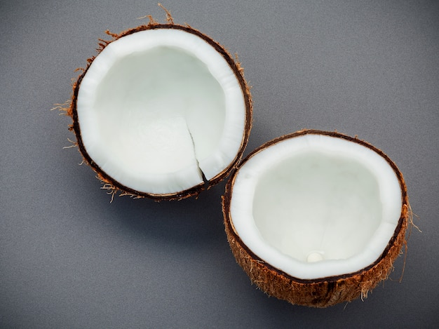 Whole of coconut shell on gray background flat lay and copy space. top view