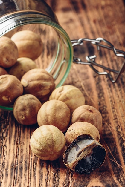 Whole and crushed dried limes on wooden table