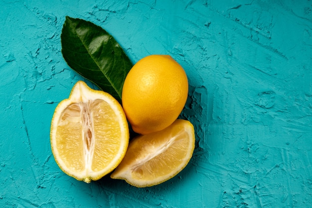 Photo whole and cut lemon on a blue background, food background.