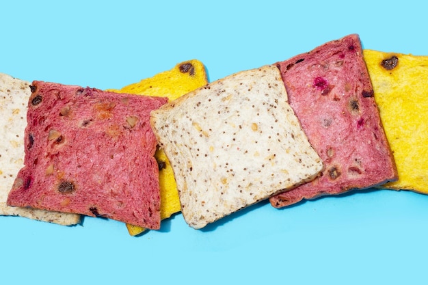 Whole grain bread slices on blue background