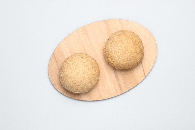 Whole grain buns on a gray table