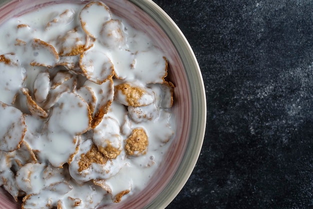 Whole grain glazed flakes with yogurt in plate Healthy breakfast whole grain muesli in a bowl