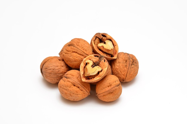 Whole and halved walnuts isolated on white background