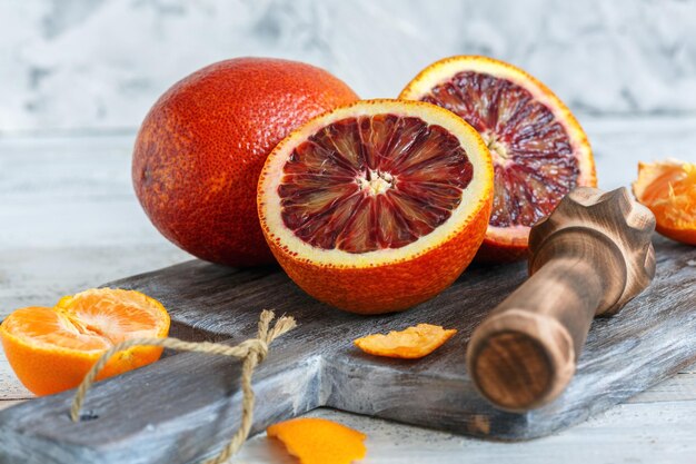 Whole and halves of blood orange and citrus press