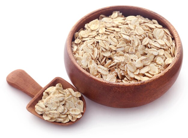 Whole oats in bowl over white background