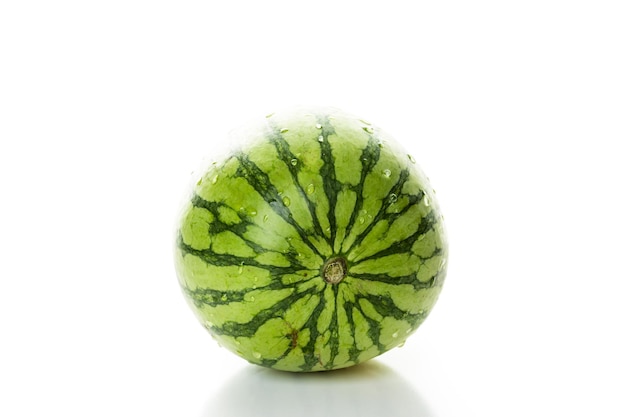 Whole organic mini watermelon on a white background.