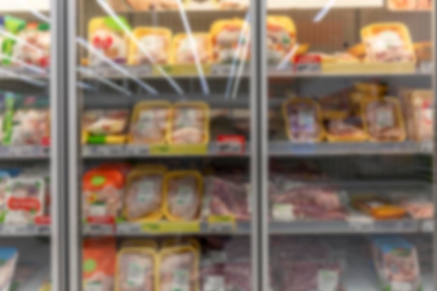 Whole and parts of chilled chickens in packaging on a shelf in a store Health healthy food and food crisis Closeup Front view Blurred