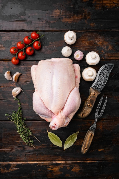 Whole raw chicken set on old dark wooden table background top view flat lay