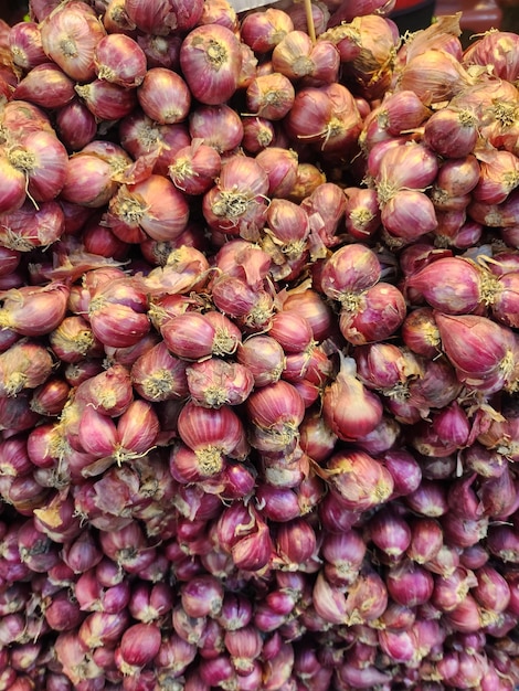 Whole red shallots kept in market place for sale in India Healthy eating food vegetable