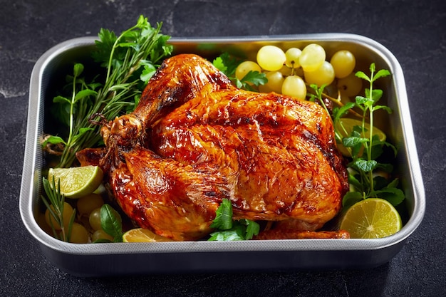 Whole roast chicken in a baking dish