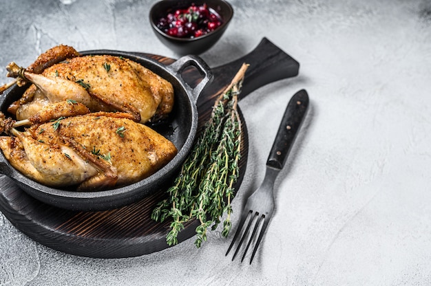 Whole roast quails in a pan