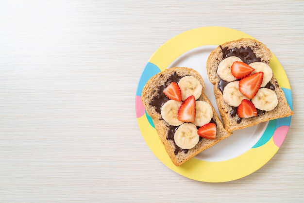 whole wheat bread with fresh banana, strawberry and chocolate