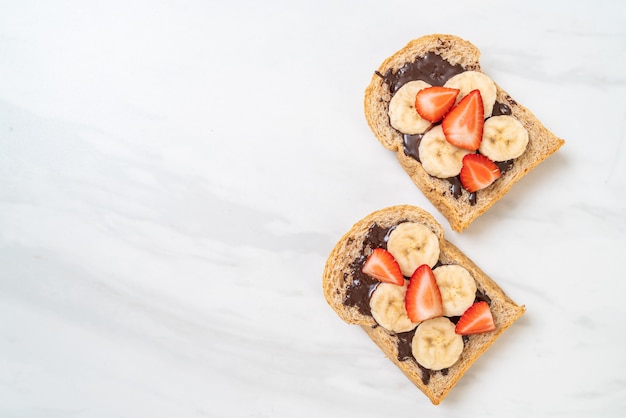 whole wheat bread with fresh banana, strawberry and chocolate