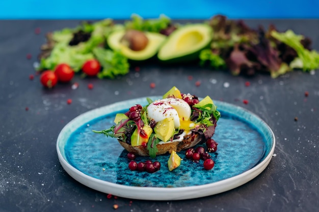 Whole wheat toasted bread with avocado poached egg soft cheese and mix salad Healthy diet food breakfast