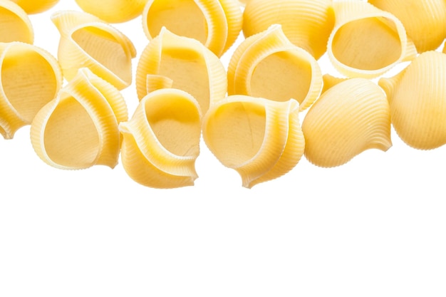 Wholegrain Italian pasta shells isolated on white