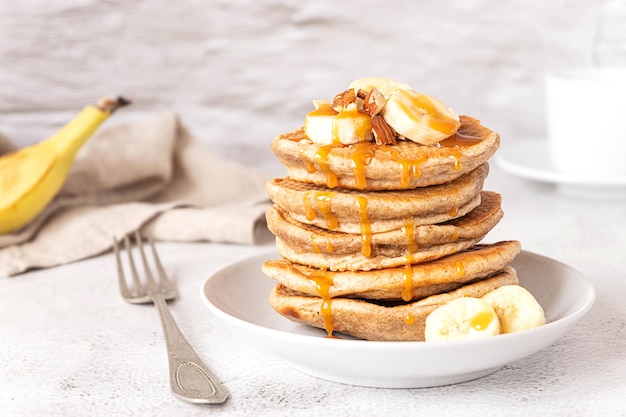 Wholegrain pancakes with banana and caramel sauce delicious breakfast