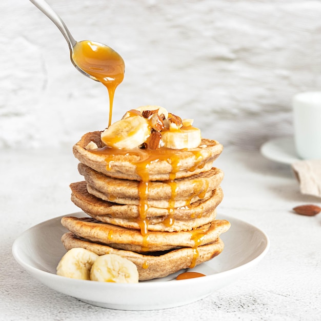 Wholegrain pancakes with banana and caramel sauce delicious breakfast