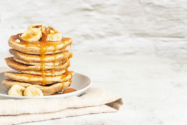 Wholegrain pancakes with banana and caramel sauce delicious breakfast