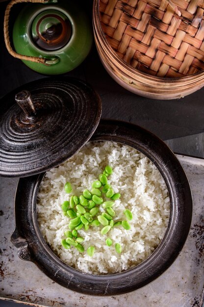 Wholesome Fusion Top CloseUp of Edamame Served on Steamed White Rice in a Cast Iron Pot in 4k