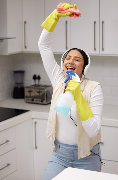 Why not make cleaning fun. Shot of a young woman listening to music and having fun while doing chores.