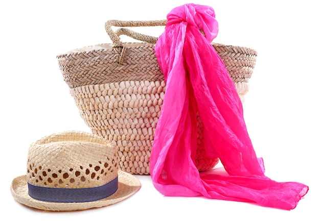 Wicker bag with hat and colorful scarf isolated on white